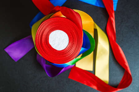 ribbons in the color of the lgbt rainbow flag in bobins, using how to celebrate homosexual, gay, lesbian and concept, top viewの写真素材