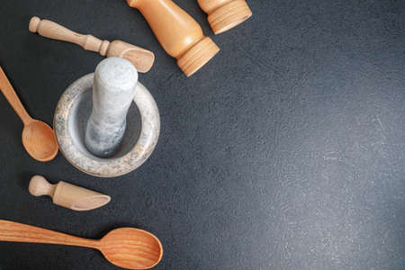 stone mortar and wooden spoon for lights on the table top view, copies space
