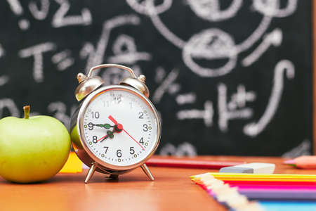 school still life, alarm clock, apple in the background school board, universityの写真素材