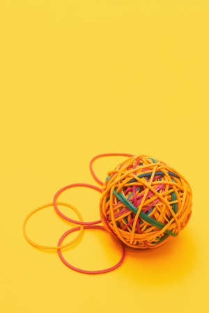 rubber band ball on yellow background flat lay copy spaceの写真素材