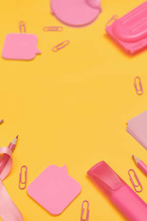 Minimalism, Back to school concept, Pink school supplies on yellow background, flat lay copy spaceの写真素材