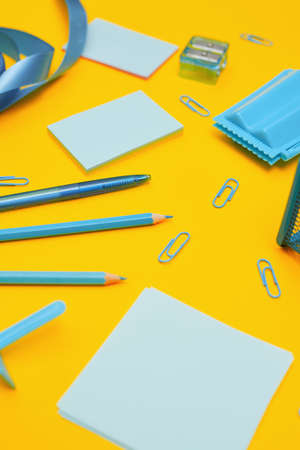 Minimalism, Back to school concept, blue school supplies on yellow background,copy spaceの写真素材