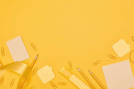 Minimalism, Back to school concept Yellow school supplies on yellow background, flat lay copy spaceの写真素材