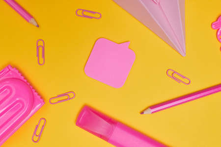 Minimalism, Back to school concept pink school supplies on yellow background, flat lay withの写真素材