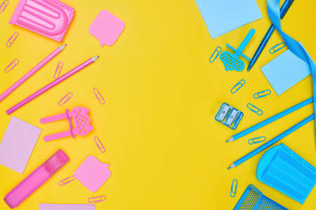 Minimalism, Back to school concept, blue and pink school supplies on yellow background, flat lay...