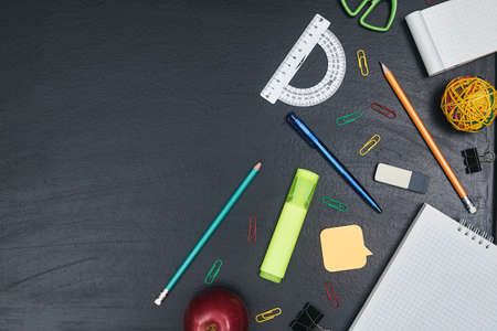 back to school, school supplies on black chalkboard, copy space, top