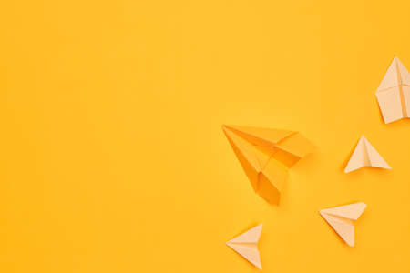 minimalism yellow paper planes on a yellow background. travel, flight, flat layer, copy space oneの写真素材