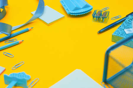 Minimalism, Back to school concept, blue school supplies on yellow backgroundの写真素材