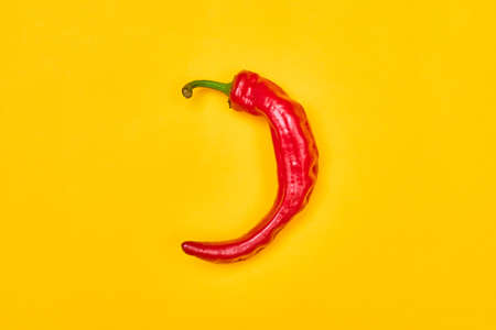 red hot pepper on a yellow background top view one