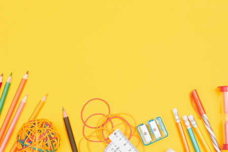 Back to school concept, school supplies on yellow background,flat lay with copy space