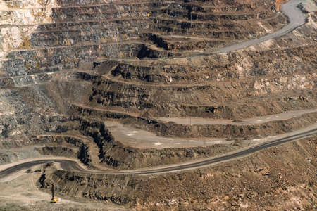 an iron ore quarry, a road of stepped terraced relief, Mining industry. Mine and quarry equipment.