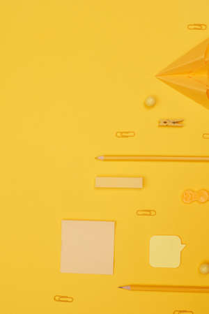 back to school, school supplies lying parallel on yellow background, copy space, top viewの写真素材
