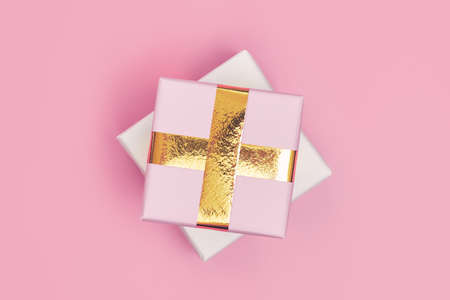 christmas gift with gold ribbon on pink background isolate, copyspace, layoutの写真素材