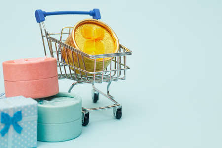 black friday concept, gift boxes with shopping trolley on blue pastel background, copy space