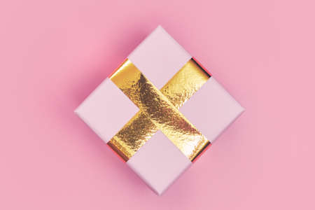 christmas gift with gold ribbon on pink background isolate, copyspace, layout