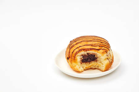 chocolate bitten donut on white background isolate, copy spaceの写真素材