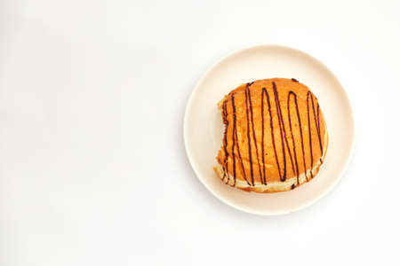 chocolate bitten donut on white background isolate, copy space, top viewの写真素材