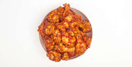 Buffalo chicken wings in a plate on a white background, copy spaceの写真素材
