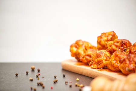 Buffalo chicken wings on wooden board with celery copies spaceの写真素材