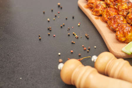 Buffalo chicken wings on wooden board with celery copies spaceの写真素材