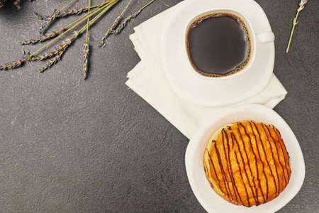 donut on the table and a cup of coffee, top viewの写真素材