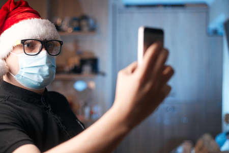 Christmas concept, caucasian man wearing medical mask and santa hatの写真素材