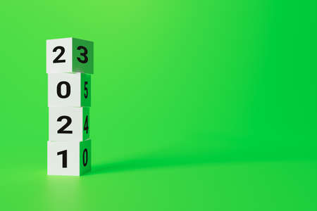 christmas concept, written on white cubes 2021 on a green background, copy spaceの写真素材