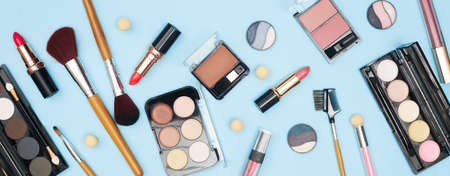 set of professional cosmetics, makeup tools and accessories on blue background, beauty, fashion, shopping concept, flat laの写真素材