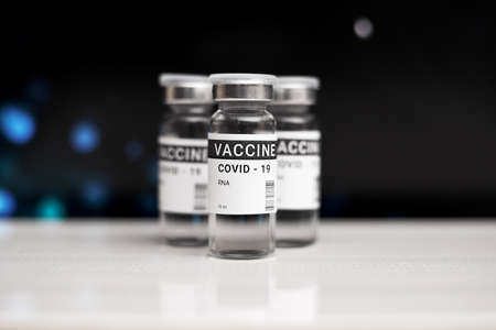 Three cans of coronavirus vaccine. against a black background. copy space, bannerの写真素材