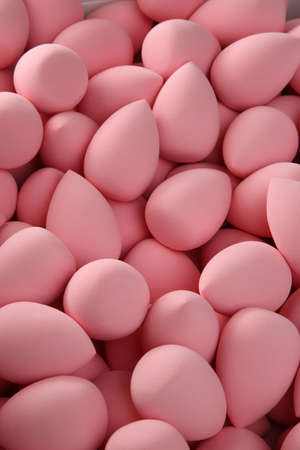 beauty background a bunch of pink gentle makeup sponges vertical orientationの写真素材