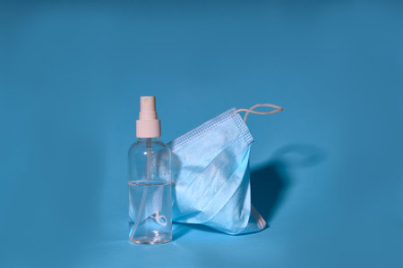 Sanitary alcohol or antibacterial liquid and surgical masks as protection against the corona virus. Codvid-19 news and protection in quarantines.の写真素材