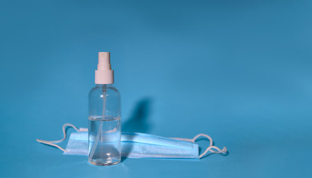 Sanitary alcohol or antibacterial liquid and surgical masks as protection against the corona virus. Codvid-19 news and protection in quarantines.の写真素材