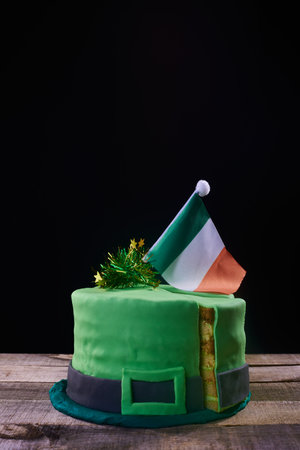 green frosting cake shaped like a green hat with an Irish flag on top, to celebrate St. Patrick's Day. separate laminated portionの写真素材