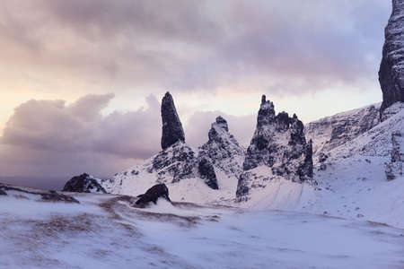 Old Man Storr, Isle Skye, Scotland. Winter, very snowy mountain in a very powerful sunrise. first...