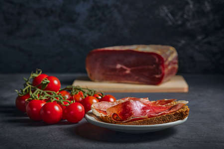 prepared and delicious food. Serrano ham on rye toast, with olive oil and tomatoes.の写真素材