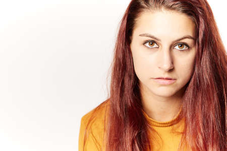 Portrait of optimistic redhair girl. Grey color background with Copy Space area, for some advertising text or sloganの写真素材