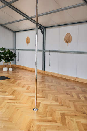 woman face down suspended on pole bar. body conscious concept.の写真素材