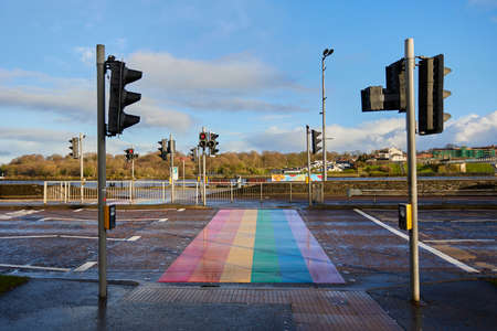 LONDONDERRY - NORTH IRELAND - JANUARY 01-2022 zebra crossing painted in LGBT flag colors, concept...