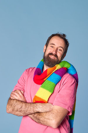 bearded adult lgtb man wearing a scarf with lgtb pride colors. casual clothes, vertical imageの写真素材
