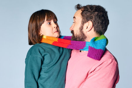 portrait of divorced lgbt father with his daughter in studio on isolated background. happy family relationshipの写真素材