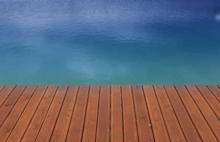 Wooden wharf and blue waterの写真素材