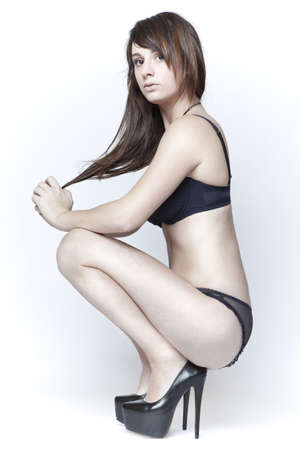 beautiful young girl in black lingerie and high heelsの写真素材