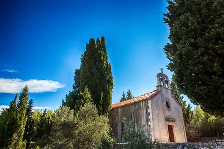old stone rustic church and blue summer skyの写真素材