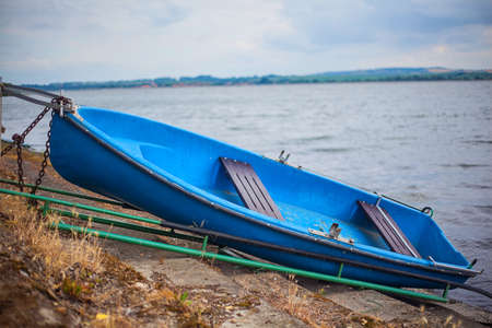 romantic old small boat on shoreの写真素材