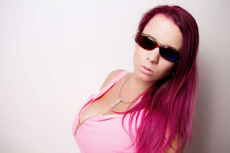 attractive portrait girl in pink clothes with sunglassesの写真素材