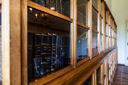 Old books in a wooden row library