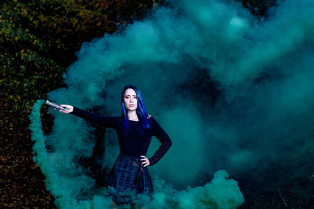 attractive cute girl with green dark smokeの写真素材