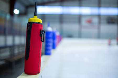 drink red bottle on board ice hockey rinkの写真素材