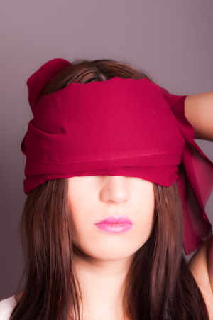 portrait of girl with eyes coveredの写真素材