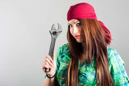 portrait of attractive girl holding adjustable wrenchの写真素材